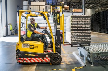 a worker driving a forklift